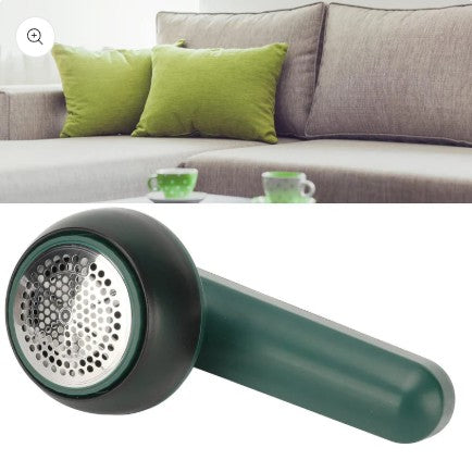 Electric Lint Remover with a blurred living room background