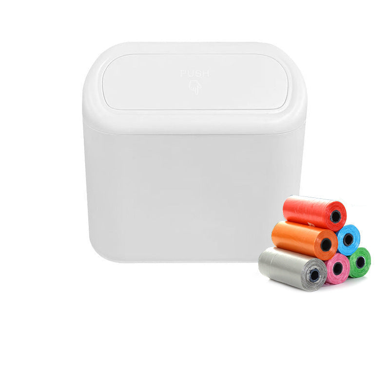 White trash bin with colorful rolls of disposable bags on a white background