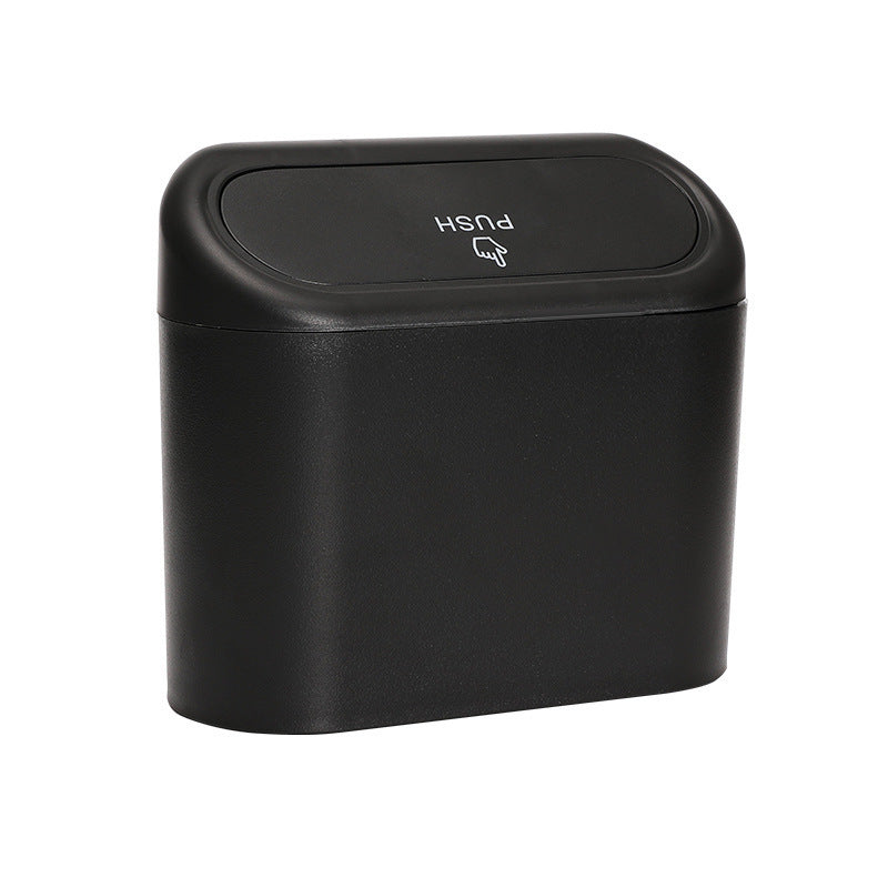 Black trash bin with push lid on a white background