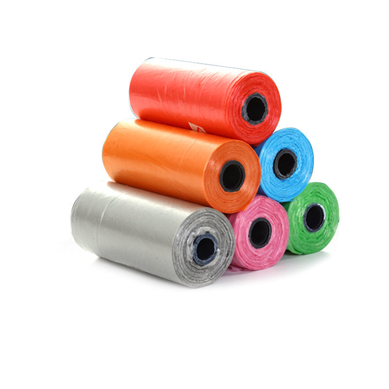 Stack of colorful rolls of plastic bags on a white background.