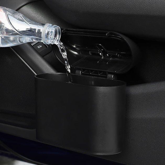 Car cup holder with water being poured into it, showing its capacity and design.